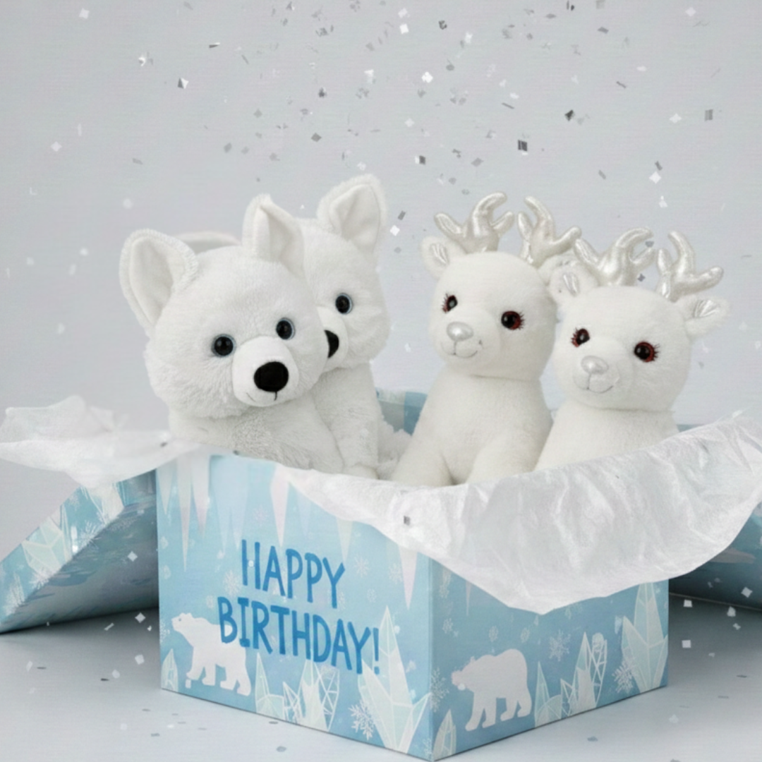 Three white stuffed animals in a 'Happy Birthday!' box on a light gray background