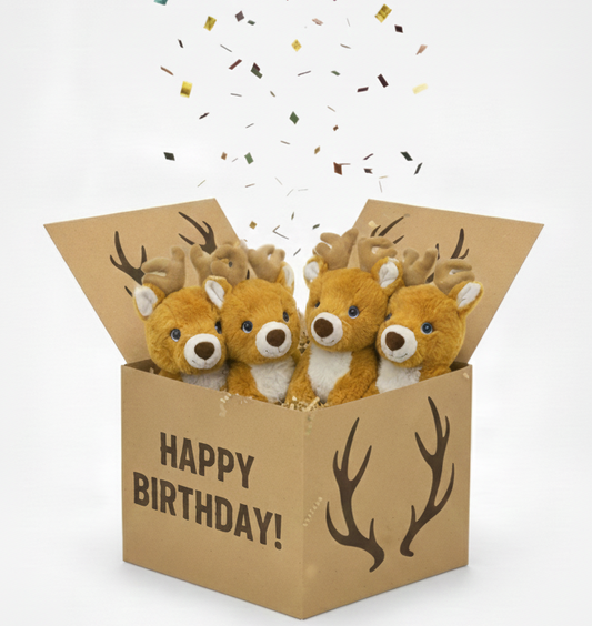 Three plush deer toys in a 'Happy Birthday!' box with confetti on a white background