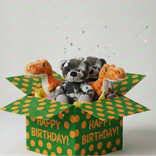 Three stuffed animals in a green 'Happy Birthday!' box on a light gray background