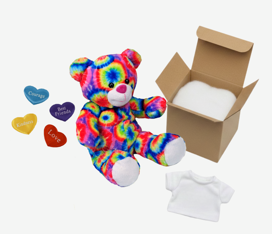 Colorful tie-dye teddy bear with small hearts and a cardboard box on a white background